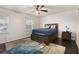 Cozy bedroom featuring dark wood floors and a ceiling fan, filled with natural light at 5664 Colton Dr, Atlanta, GA 30342