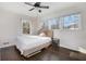 Bright bedroom boasting hardwood floors and large windows offering serene outdoor views at 5664 Colton Dr, Atlanta, GA 30342