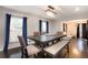 Bright dining room boasts hardwood floors, and seating for six under a modern chandelier at 5664 Colton Dr, Atlanta, GA 30342