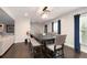 Bright dining room features hardwood floors, modern chandelier and seating for six at 5664 Colton Dr, Atlanta, GA 30342