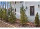 Welcoming front entrance with a stylish door, brick accents, and professionally landscaped bushes at 5664 Colton Dr, Atlanta, GA 30342