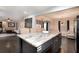 Open-concept kitchen with island seating flows into the living room for seamless entertaining at 5664 Colton Dr, Atlanta, GA 30342