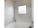 Clean, bright bathroom with a white tub and a window for natural light at 6101 Providence Way, Union City, GA 30291