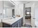 Bathroom featuring double vanity, modern lighting, and bedroom view at 6101 Providence Way, Union City, GA 30291