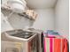 Modern laundry room featuring a washer, dryer, storage, and hanging rack at 6101 Providence Way, Union City, GA 30291