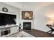 Bright living room featuring a fireplace, TV, and modern decor at 6101 Providence Way, Union City, GA 30291