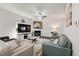 Comfortable living room featuring a fireplace, ceiling fan, and stylish decor at 6101 Providence Way, Union City, GA 30291