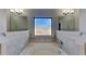 Relaxing bathroom with a soaking tub, decorative tile, and natural lighting at 8103 White Oak Loop, Stone Mountain, GA 30038