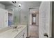 Bathroom featuring modern vanity with white marble top and bright lights, and entrance to bedroom at 8103 White Oak Loop, Stone Mountain, GA 30038