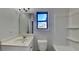 Bathroom featuring vanity with marble countertop, bathtub with shower, and window at 8103 White Oak Loop, Stone Mountain, GA 30038