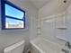 Bathroom featuring shower and bathtub, window for natural light, and white fixtures at 8103 White Oak Loop, Stone Mountain, GA 30038