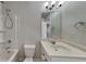 Bathroom with a tub-shower combo, vanity with marble countertop and decorative lights at 8103 White Oak Loop, Stone Mountain, GA 30038