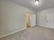 Empty bedroom with neutral walls, carpet flooring, and two large closets at 8103 White Oak Loop, Stone Mountain, GA 30038