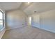 Neutral bedroom with vaulted ceiling, plush carpet, large window and ensuite bathroom at 8103 White Oak Loop, Stone Mountain, GA 30038