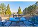 Outdoor deck area with wrought iron table and chairs, offering a serene view at 175 Hampstead Mnr, Fayetteville, GA 30214