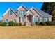 Traditional brick home with a well-manicured lawn and green shutters at 175 Hampstead Mnr, Fayetteville, GA 30214