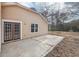 An outdoor patio featuring light tan siding, windows, and double glass doors for relaxed outdoor living at 2426 Windridge Dr, Conyers, GA 30013