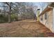 Large backyard with mature trees surrounding the perimeter of the home at 2426 Windridge Dr, Conyers, GA 30013