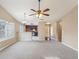 Open-concept living space with vaulted ceilings, carpeting, and views of the kitchen at 2426 Windridge Dr, Conyers, GA 30013