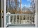 View from the balcony that features white railings overlooking the tree-lined street at 611 Irwin Ne St, Atlanta, GA 30312