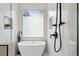 Modern bathroom featuring a soaking tub, matte black fixtures and white subway tile at 611 Irwin Ne St, Atlanta, GA 30312