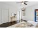 Stylish bedroom featuring a decorative mirror, a window, dark wood floors, and a blue door to the balcony at 611 Irwin Ne St, Atlanta, GA 30312