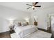 Bright bedroom with a large bed, ceiling fan and ensuite bathroom featuring dark wood floors at 611 Irwin Ne St, Atlanta, GA 30312