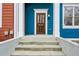 Inviting front door of blue townhome with a decorative glass pane at 611 Irwin Ne St, Atlanta, GA 30312