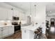Modern kitchen boasts stainless steel appliances, sleek white cabinetry, and a breakfast bar with stool seating at 611 Irwin Ne St, Atlanta, GA 30312