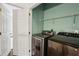 Neat laundry room includes a modern washer and dryer, with an open door to the rest of the home at 611 Irwin Ne St, Atlanta, GA 30312