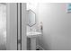 Modern half bathroom featuring a pedestal sink, hexagon mirror, and fresh decor at 975 Moda Dr, Atlanta, GA 30316