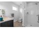 Bright bathroom features tile floors, dark wood vanity, granite countertops, and a glass shower at 975 Moda Dr, Atlanta, GA 30316