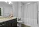 Bathroom features tile floors, dark wood vanity, granite countertop and glass-enclosed shower at 975 Moda Dr, Atlanta, GA 30316