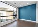 Bright bedroom features hardwood floors, a large window, neutral drapes and blue accent wall at 975 Moda Dr, Atlanta, GA 30316