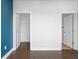 Bedroom with hardwood floors, white trim and doors to closet and en suite at 975 Moda Dr, Atlanta, GA 30316