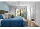 Cozy bedroom featuring hardwood floors, a large window, and an ensuite bathroom at 975 Moda Dr, Atlanta, GA 30316