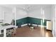 Bonus room with hardwood floors, overhead fan, workout accessories and storage cabinet at 975 Moda Dr, Atlanta, GA 30316