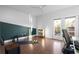 Well lit bonus room features hardwood floors, workout accessories, and a small balcony at 975 Moda Dr, Atlanta, GA 30316