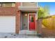 Inviting townhome entrance featuring a red door, brick accents, and modern design at 975 Moda Dr, Atlanta, GA 30316