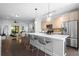 Spacious open floor plan with a kitchen island, bar seating, and stainless steel appliances at 975 Moda Dr, Atlanta, GA 30316