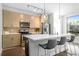 Well-lit kitchen featuring a quartz countertop island, stainless steel appliances, and modern cabinets at 975 Moda Dr, Atlanta, GA 30316
