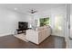 Bright living room with a comfortable sofa, ceiling fan and dark hardwood flooring at 975 Moda Dr, Atlanta, GA 30316
