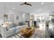 Open-concept living room with a comfortable sofa, stylish rug, and view into the modern kitchen at 975 Moda Dr, Atlanta, GA 30316