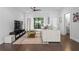 Bright living room with a comfortable sofa, ceiling fan and dark hardwood flooring at 975 Moda Dr, Atlanta, GA 30316
