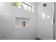 Tiled shower featuring a window, shower niche and dark tile floors at 975 Moda Dr, Atlanta, GA 30316