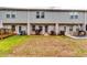 Features a backyard with a small patio, a wooden deck, and green and brown grass at 1155 Magnolia Gardens Walk, Mcdonough, GA 30253