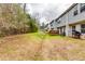 The exterior shows a backyard with green and brown grass and a wooded area at the back at 1155 Magnolia Gardens Walk, Mcdonough, GA 30253