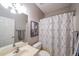 Modern bathroom with a patterned shower curtain, framed art, and a sleek vanity at 3916 Abbott Way # 2, Powder Springs, GA 30127
