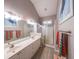 Bright bathroom with double vanity, large mirror, modern lighting, and glass-enclosed shower at 3916 Abbott Way # 2, Powder Springs, GA 30127