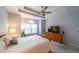 Cozy bedroom with tray ceiling, neutral carpet, ceiling fan, and large window allowing natural light at 3916 Abbott Way # 2, Powder Springs, GA 30127